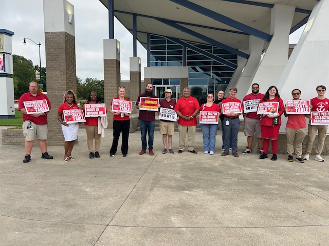 Many NNEA members and supporters wearing red outside the August 19th school board meeting.